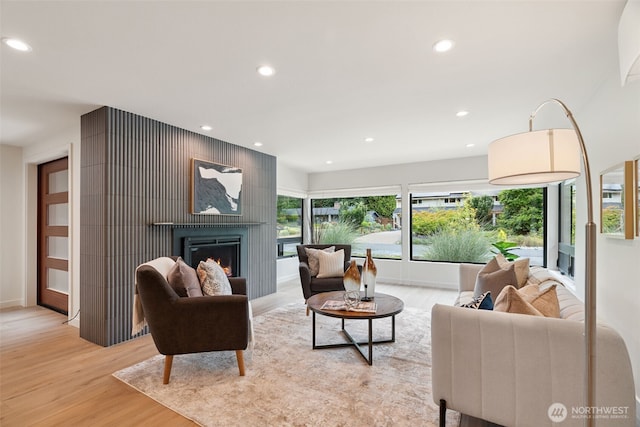 23406 Humber Ln, Edmonds, WA 98020 - living area with light wood-style floors, a glass covered fireplace, and recessed lighting