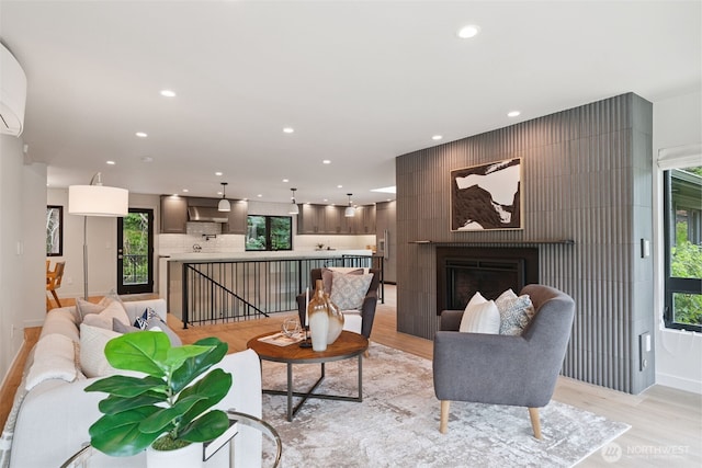 23406 Humber Ln, Edmonds, WA 98020 - living room featuring light wood-style flooring, recessed lighting, and a fireplace