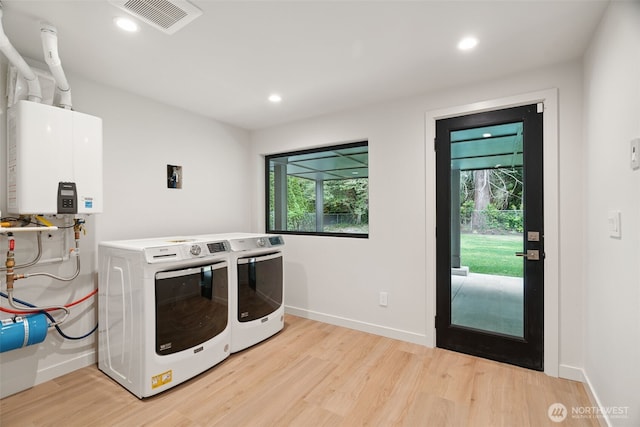23406 Humber Ln, Edmonds, WA 98020 - laundry room featuring light wood finished floors, tankless water heater, recessed lighting, and washer and dryer