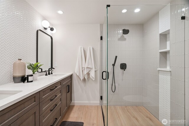 23406 Humber Ln, Edmonds, WA 98020 - full bath featuring double vanity, tiled shower, wood finished floors, and recessed lighting