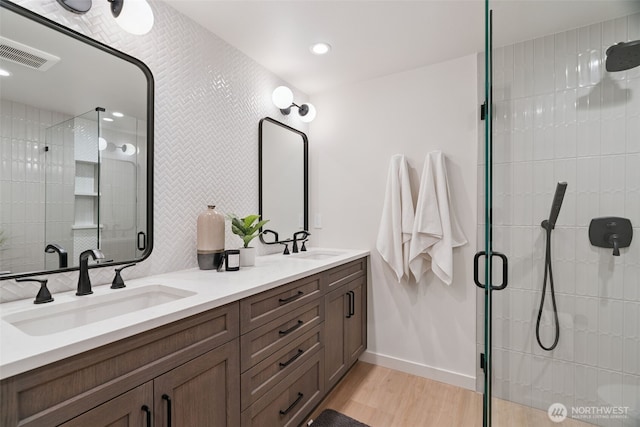 23406 Humber Ln, Edmonds, WA 98020 - full bathroom featuring a stall shower, double vanity, wood finished floors, and recessed lighting