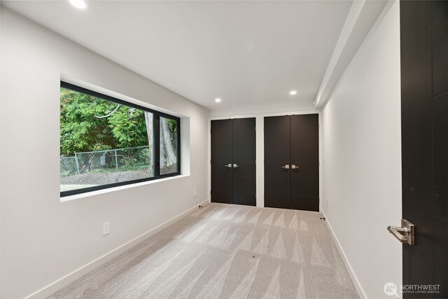 23406 Humber Ln, Edmonds, WA 98020 - unfurnished bedroom with recessed lighting, light carpet, and two closets