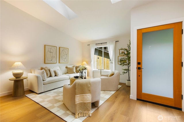 14703 121st Ct NE, Kirkland, WA 98034 - living area featuring a skylight, wood finished floors, and lofted ceiling