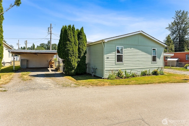 10900 Kuhlmann Rd SE Unit 50, Olympia, WA 98513 - manufactured / mobile home featuring driveway and a detached carport