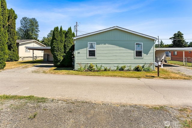 10900 Kuhlmann Rd SE Unit 50, Olympia, WA 98513 - view of side of home with driveway and an attached carport