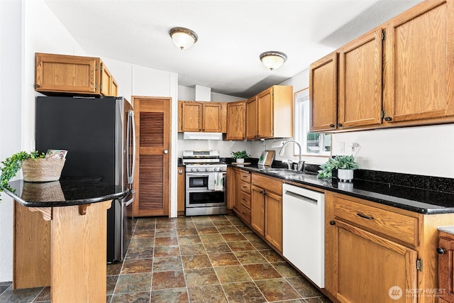 10900 Kuhlmann Rd SE Unit 50, Olympia, WA 98513 - kitchen featuring gas stove, dishwasher, freestanding refrigerator, vaulted ceiling, and dark stone finish floors