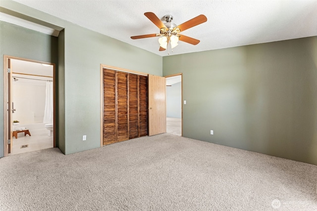10900 Kuhlmann Rd SE Unit 50, Olympia, WA 98513 - unfurnished bedroom with carpet flooring, a closet, a ceiling fan, and ensuite bathroom