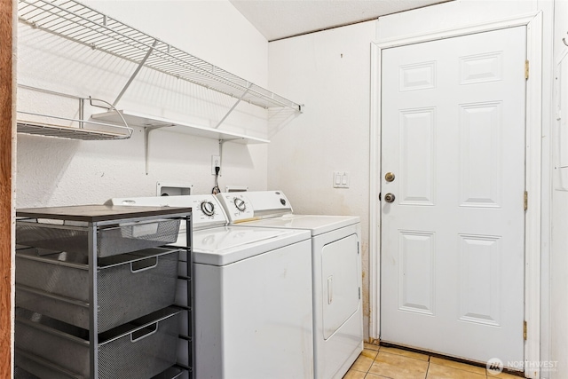 10900 Kuhlmann Rd SE Unit 50, Olympia, WA 98513 - washroom with washer and clothes dryer and light tile patterned floors
