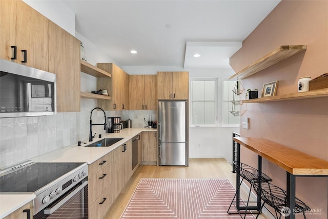 8455 Delridge Way SW, Seattle, WA 98106 - kitchen featuring open shelves, stainless steel appliances, light wood-style flooring, light brown cabinets, and light countertops