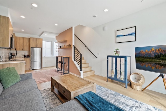 8455 Delridge Way SW, Seattle, WA 98106 - living room featuring light wood-style floors, recessed lighting, and stairs