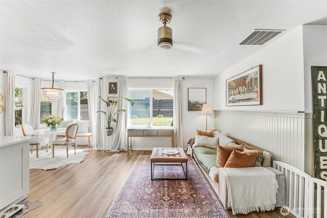 15922 Lindsay Rd SE, Yelm, WA 98597 - living area featuring light wood-style flooring, healthy amount of natural light, and a textured ceiling