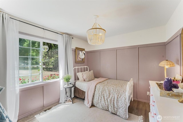 15922 Lindsay Rd SE, Yelm, WA 98597 - bedroom with a chandelier, a decorative wall, and wood finished floors