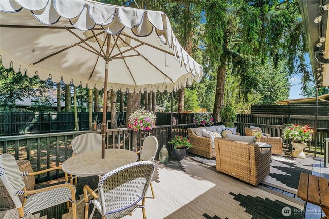 15922 Lindsay Rd SE, Yelm, WA 98597 - wooden terrace featuring outdoor dining space, a fenced backyard, and an outdoor hangout area