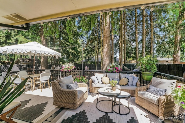 15922 Lindsay Rd SE, Yelm, WA 98597 - fenced backyard with outdoor dining area, an outdoor hangout area, and a wooden deck