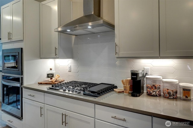29207 217th Pl SE Unit 1, Black Diamond, WA 98010 - kitchen with wall chimney range hood, appliances with stainless steel finishes, backsplash, white cabinetry, and light countertops