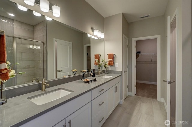 29207 217th Pl SE Unit 1, Black Diamond, WA 98010 - full bathroom featuring double vanity, a stall shower, and a spacious closet