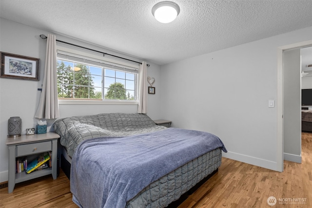 4709 144th St E, Tacoma, WA 98446 - bedroom featuring light wood-style floors and a textured ceiling