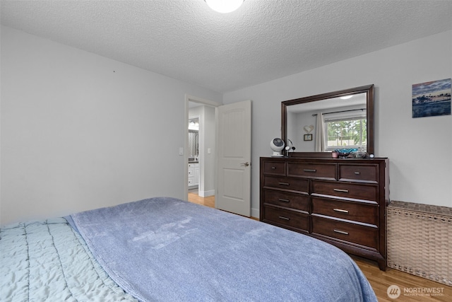4709 144th St E, Tacoma, WA 98446 - bedroom featuring light wood-type flooring and a textured ceiling