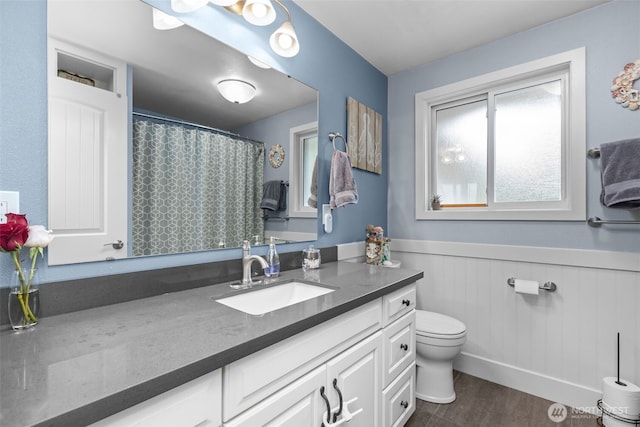 4709 144th St E, Tacoma, WA 98446 - full bath featuring vanity, a wainscoted wall, wood finished floors, and curtained shower