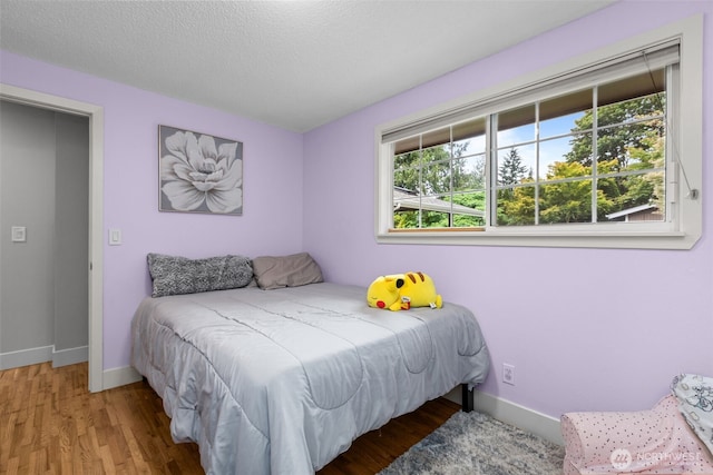 4709 144th St E, Tacoma, WA 98446 - bedroom featuring baseboards and wood finished floors