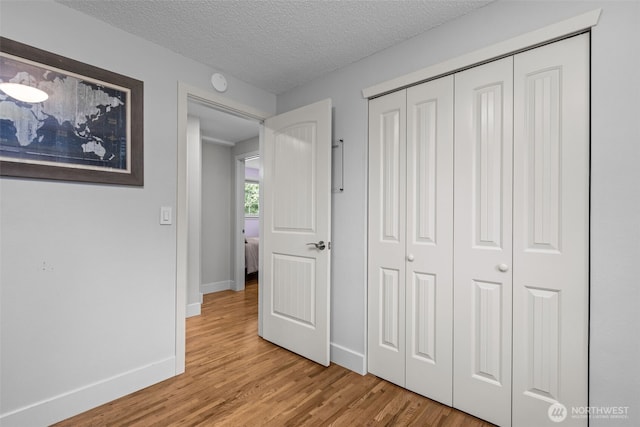 4709 144th St E, Tacoma, WA 98446 - unfurnished bedroom with light wood-type flooring, a closet, and a textured ceiling