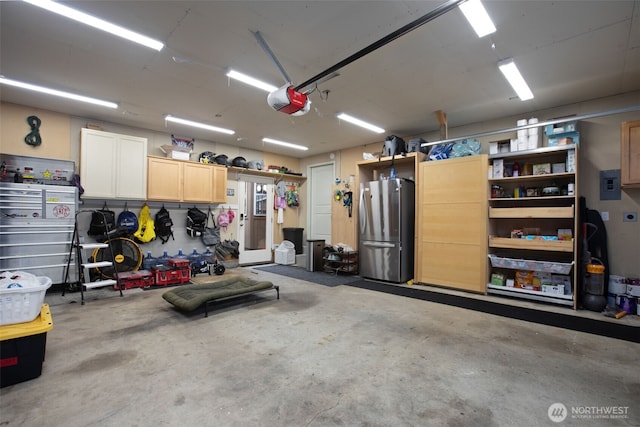 4709 144th St E, Tacoma, WA 98446 - garage with freestanding refrigerator, electric panel, and a garage door opener