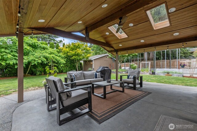 4709 144th St E, Tacoma, WA 98446 - view of patio / terrace with an outdoor living space, a storage unit, and a grill