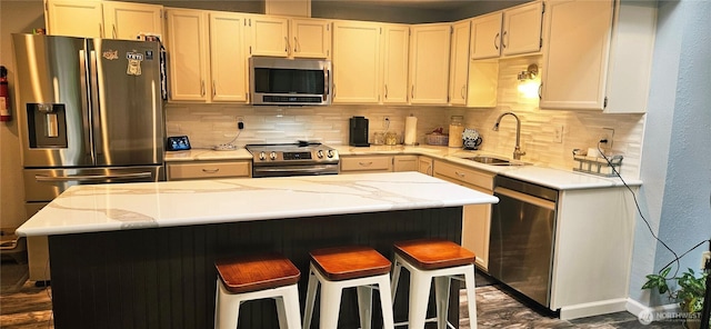 31505 46th Ave S, Auburn, WA 98001 - kitchen featuring appliances with stainless steel finishes, backsplash, a breakfast bar, and a center island