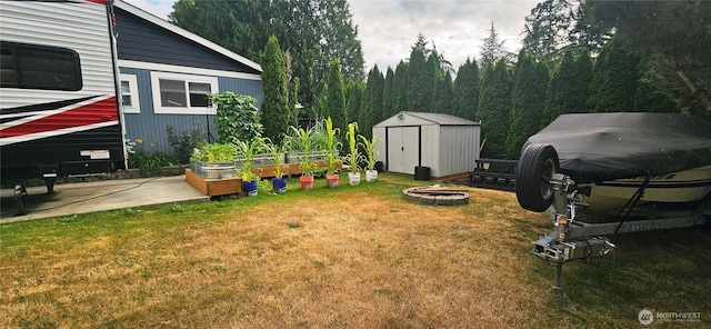 31505 46th Ave S, Auburn, WA 98001 - view of green lawn featuring a storage shed, a garden, and an outdoor fire pit