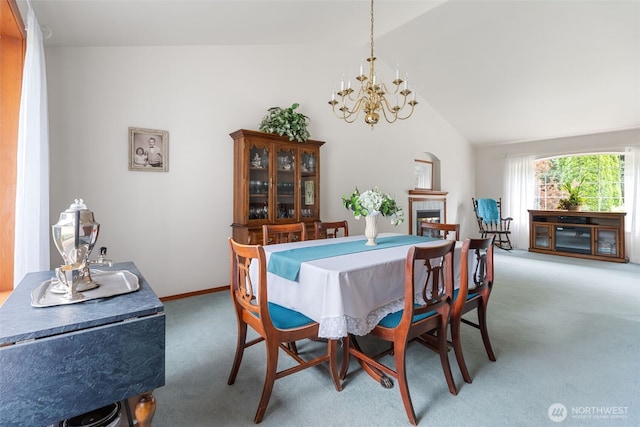 3517 Frogs Leap Ln NE, Olympia, WA 98506 - dining area featuring light carpet, lofted ceiling, a chandelier, and a fireplace