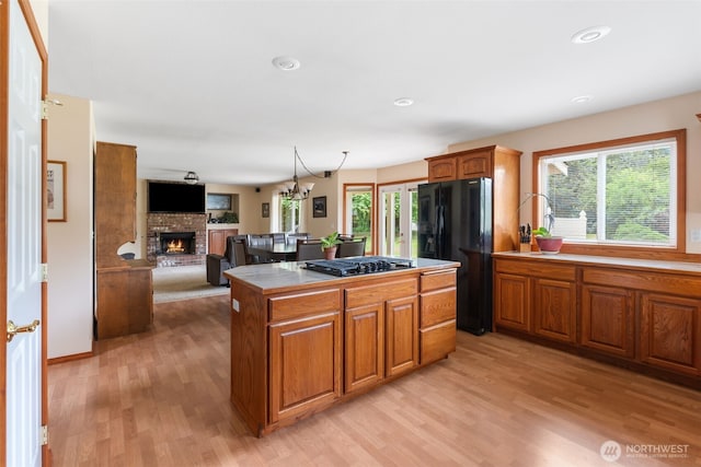 3517 Frogs Leap Ln NE, Olympia, WA 98506 - kitchen with black fridge with ice dispenser, gas cooktop, a fireplace, plenty of natural light, and recessed lighting