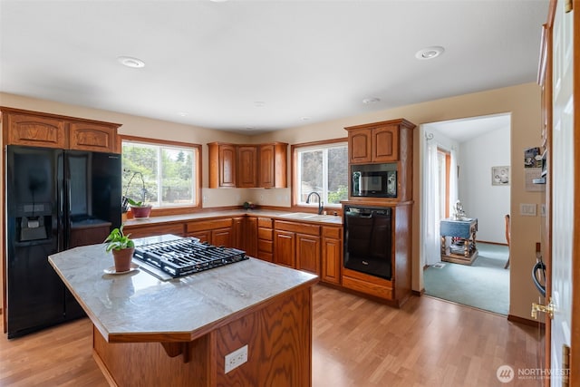 3517 Frogs Leap Ln NE, Olympia, WA 98506 - kitchen with black appliances, brown cabinetry, light wood finished floors, light countertops, and a kitchen island