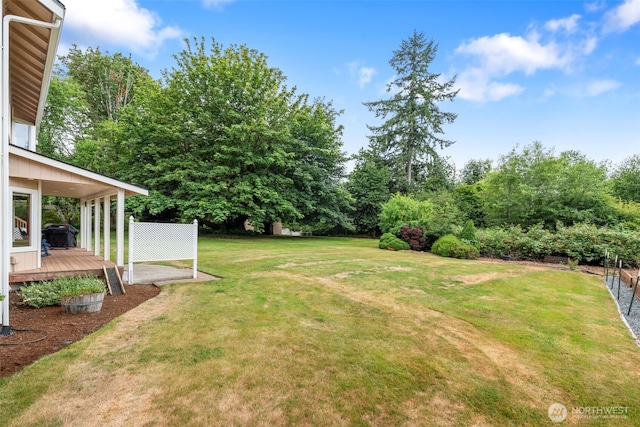 3517 Frogs Leap Ln NE, Olympia, WA 98506 - view of green lawn featuring a deck and view of scattered trees