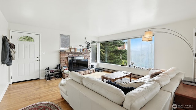 1001 1st Ave N, Seattle, WA 98109 - living room featuring light wood-style floors and a stone fireplace