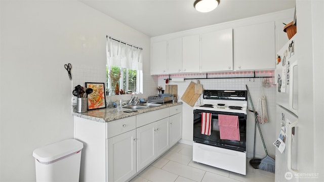 1001 1st Ave N, Seattle, WA 98109 - kitchen featuring electric range, tasteful backsplash, white cabinetry, light countertops, and light tile patterned flooring