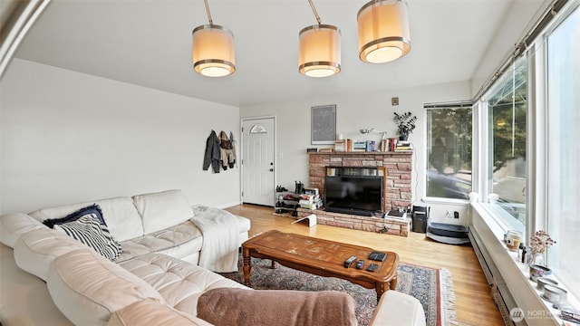 1001 1st Ave N, Seattle, WA 98109 - living room with healthy amount of natural light, wood finished floors, and a stone fireplace