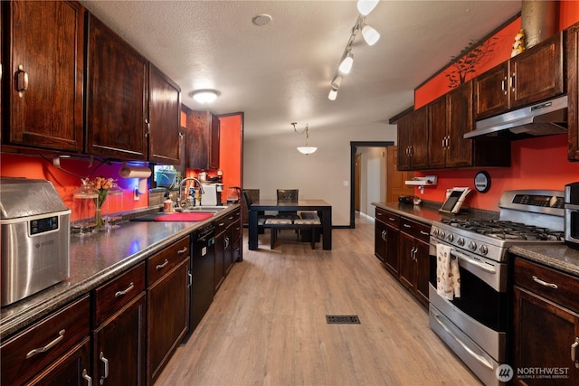 5818 Everson Goshen, Bellingham, WA 98226 - kitchen with gas stove, under cabinet range hood, dishwasher, light wood finished floors, and dark countertops