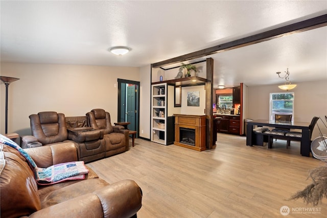 5818 Everson Goshen, Bellingham, WA 98226 - living room with light wood-type flooring, a fireplace, and beam ceiling