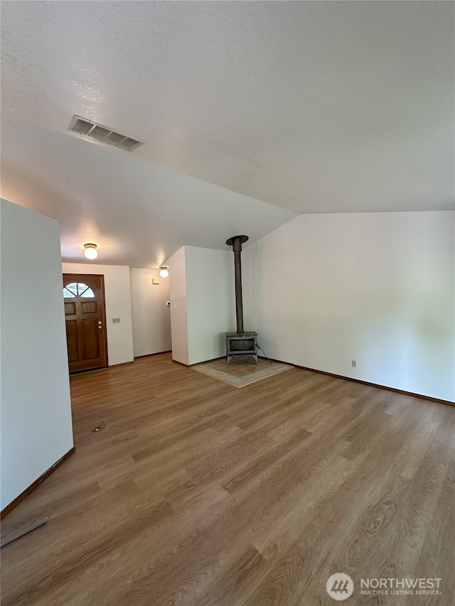 1430 Welling Rd, Bellingham, WA 98226 - unfurnished living room with a wood stove, wood finished floors, and lofted ceiling