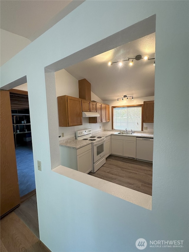 1430 Welling Rd, Bellingham, WA 98226 - kitchen with white appliances, dark wood-style floors, under cabinet range hood, lofted ceiling, and light countertops
