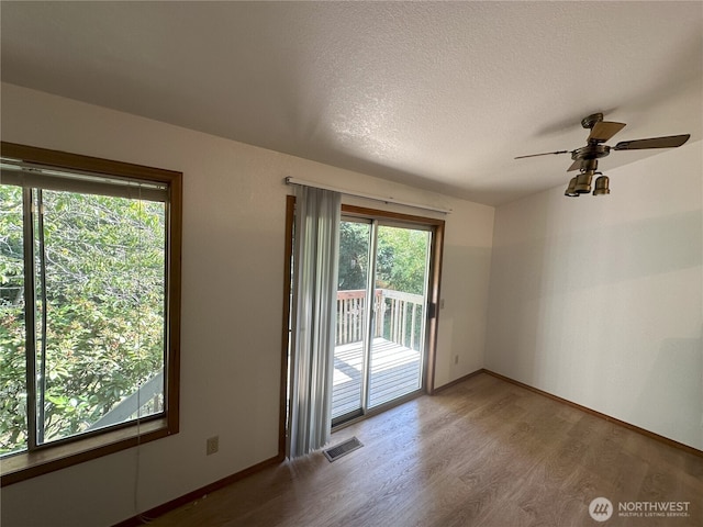 1430 Welling Rd, Bellingham, WA 98226 - spare room featuring wood finished floors, ceiling fan, and a textured ceiling
