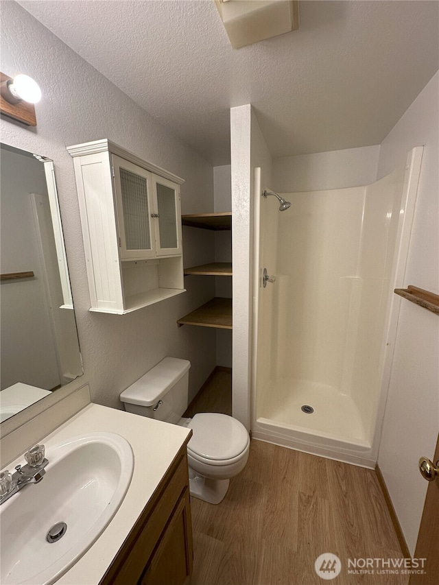 1430 Welling Rd, Bellingham, WA 98226 - bathroom featuring wood finished floors, a shower, vanity, and a textured ceiling