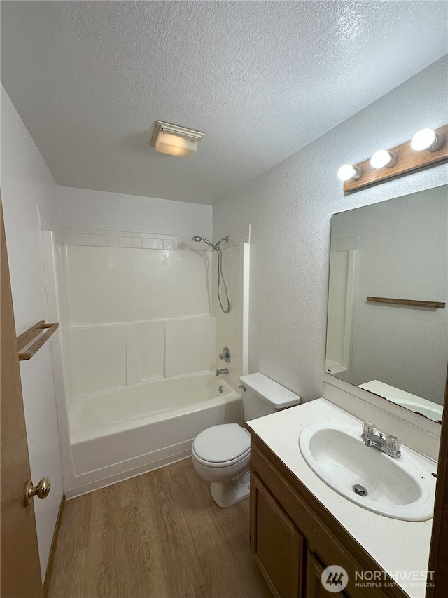 1430 Welling Rd, Bellingham, WA 98226 - bathroom featuring wood finished floors, a textured ceiling, shower / tub combination, and vanity