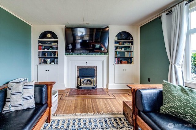 1008 W 5th St N, Port Angeles, WA 98363 - living room featuring built in shelves, a wood stove, and wood finished floors