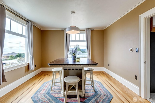 1008 W 5th St N, Port Angeles, WA 98363 - dining room with healthy amount of natural light, light wood-style flooring, and ornamental molding