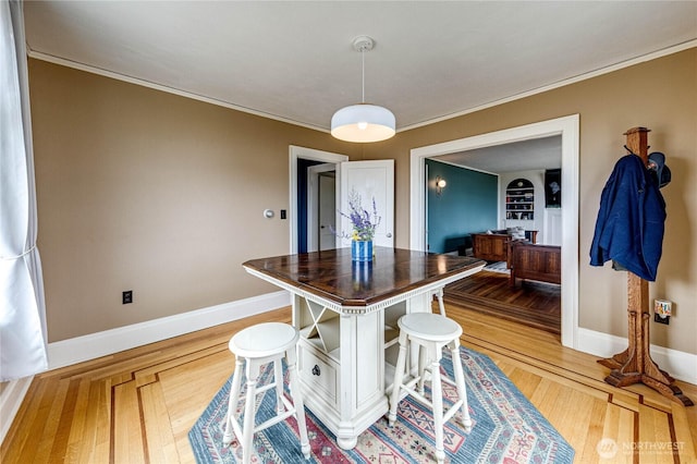 1008 W 5th St N, Port Angeles, WA 98363 - dining area with ornamental molding, light wood finished floors, and built in shelves