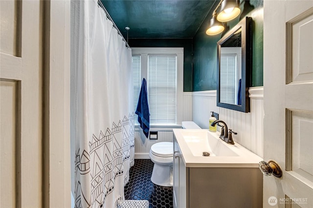 1008 W 5th St N, Port Angeles, WA 98363 - full bath with vanity, wainscoting, and a shower with curtain