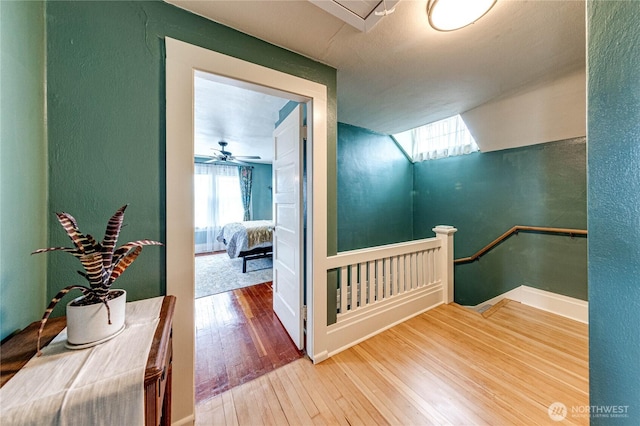 1008 W 5th St N, Port Angeles, WA 98363 - hallway featuring wood-type flooring, an upstairs landing, plenty of natural light, and a textured wall