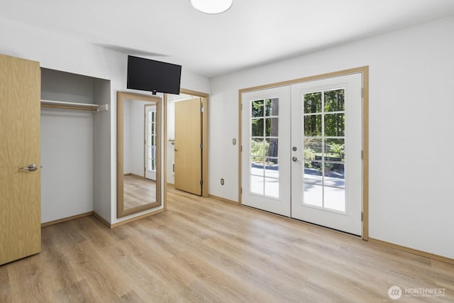 17701 Vine Ln SE, Yelm, WA 98597 - unfurnished bedroom with french doors, access to exterior, light wood-style flooring, and a closet