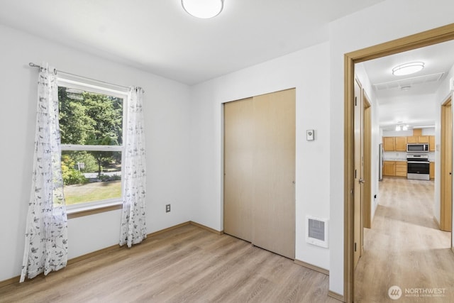 17701 Vine Ln SE, Yelm, WA 98597 - unfurnished bedroom featuring light wood-style flooring and a closet